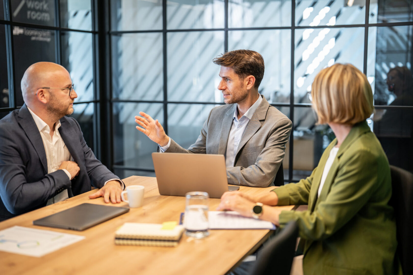 Group of business professionals discussing ideas and working together in a contemporary workspace