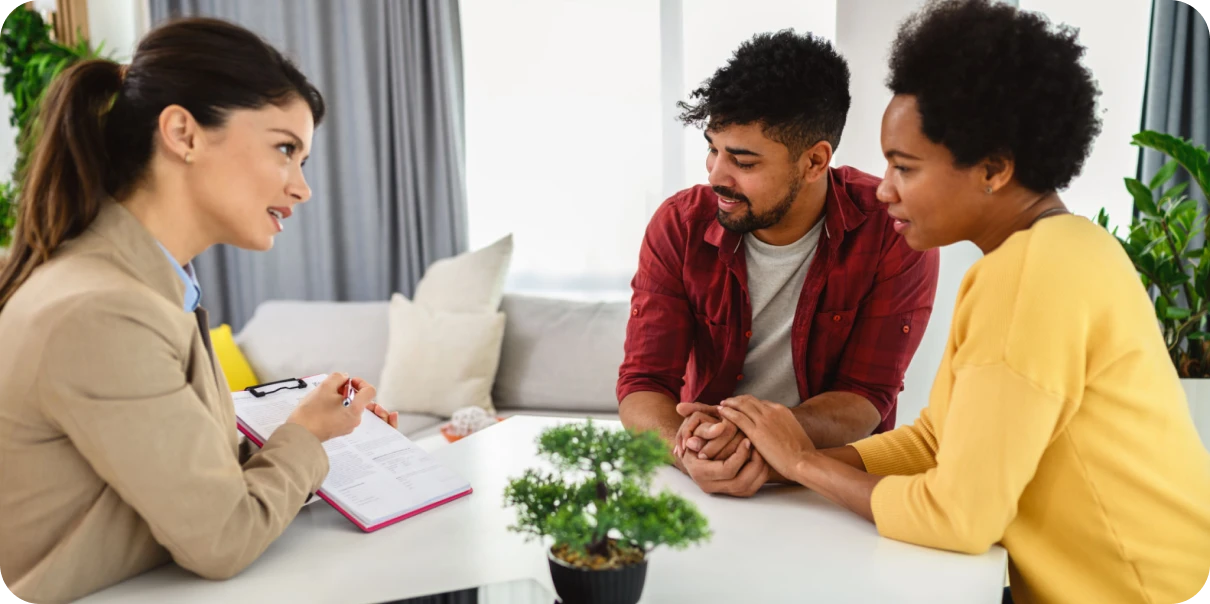 Couple consulting with a professional advisor indoors.